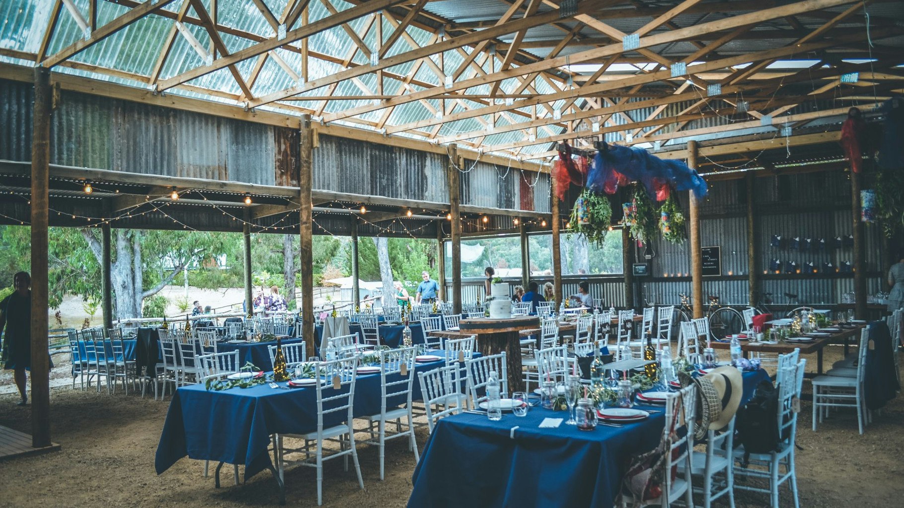Table settings styled for a country barn wedding reception.
